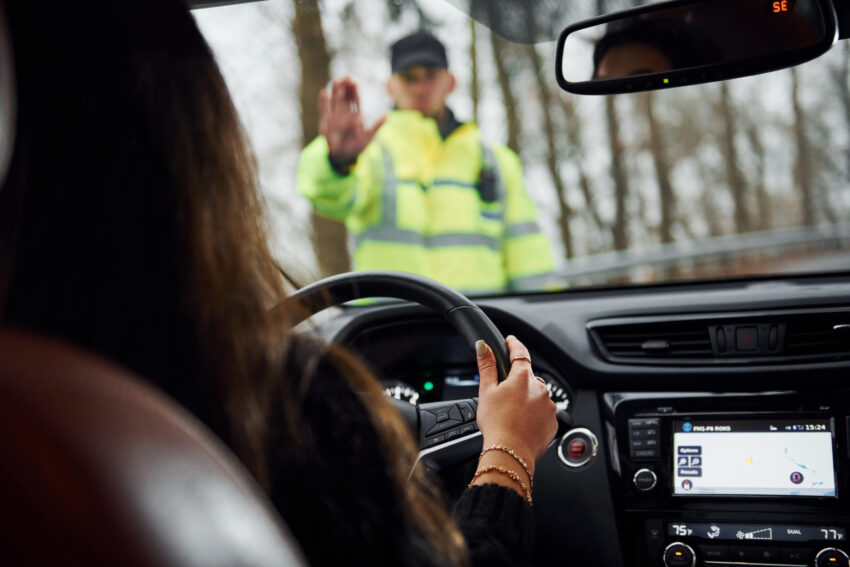 Mulher ao volante a ser mandada parar. Crédito: Magnific
